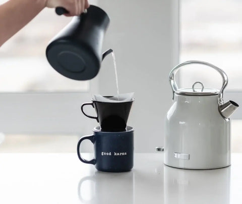 Making pour over coffee with a gooseneck kettle on a kitchen counter