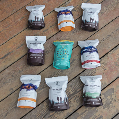 bags of twisted goat coffee on a wooden deck