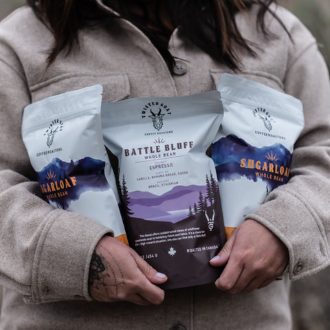 women holding 3 bags of coffee subscription