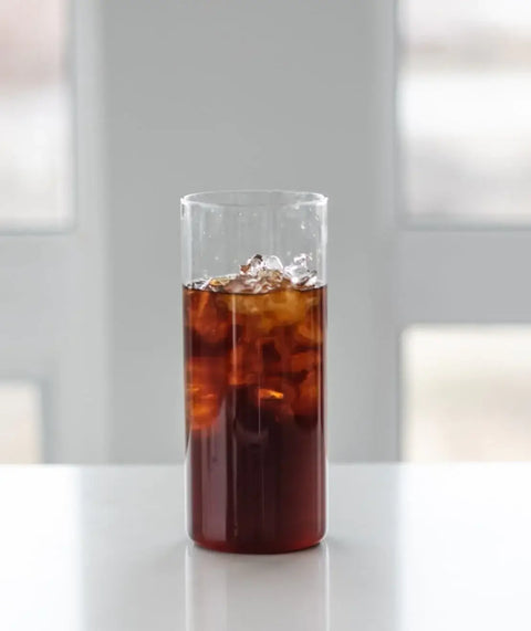 A glass of cold brew coffee on a counter top