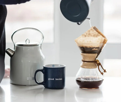 a person making coffee in a chemex coffee maker