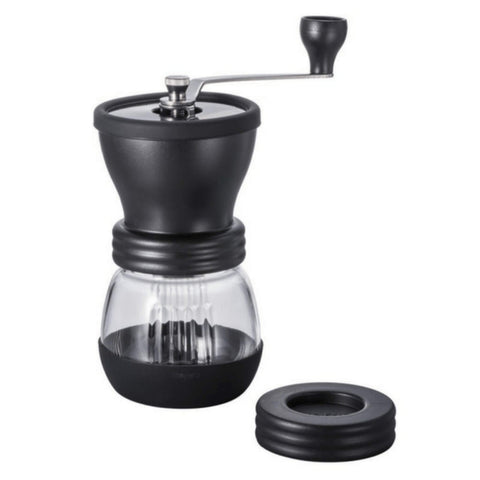 Front View Of A Black Hario Manual Coffee Grinder With Bottom Glass Chamber